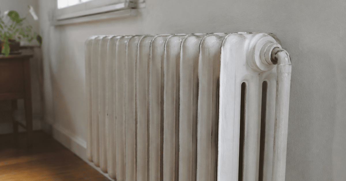 radiateur fonte ancien mur blanc surface froide au toucher
